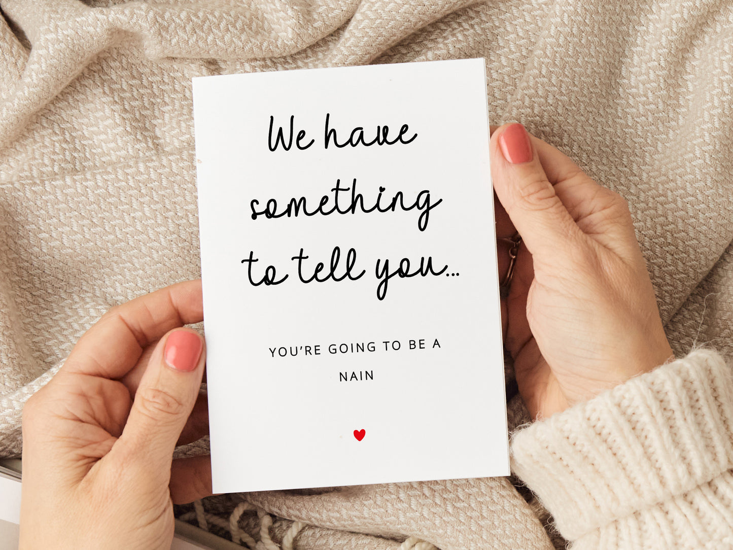 "We have something to tell you... you're going to be a Nain" pregnancy announcement card with a minimalist design.