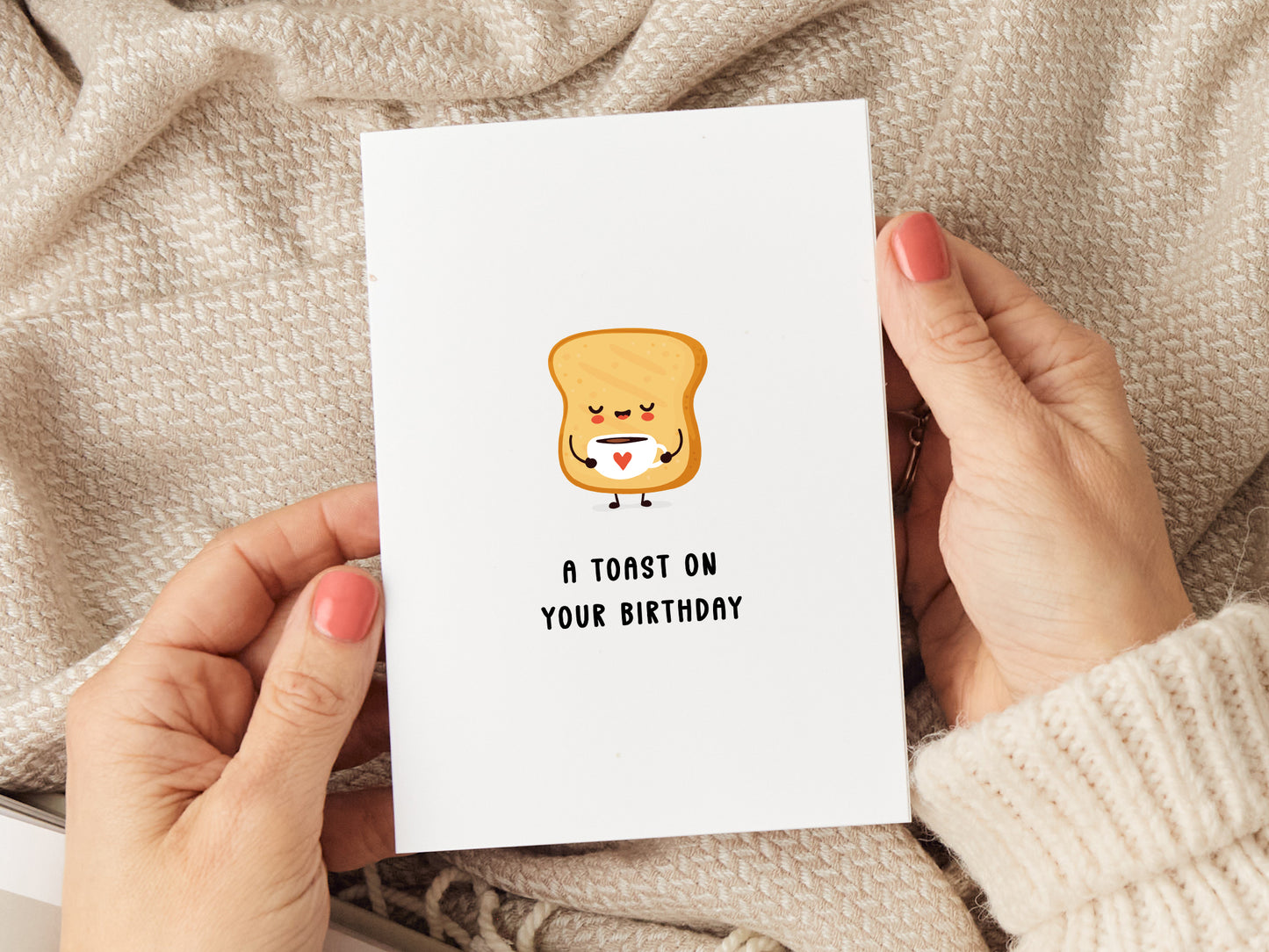 A birthday card which reads 'a toast on your birthday' with a slice of toast having a cup of tea.