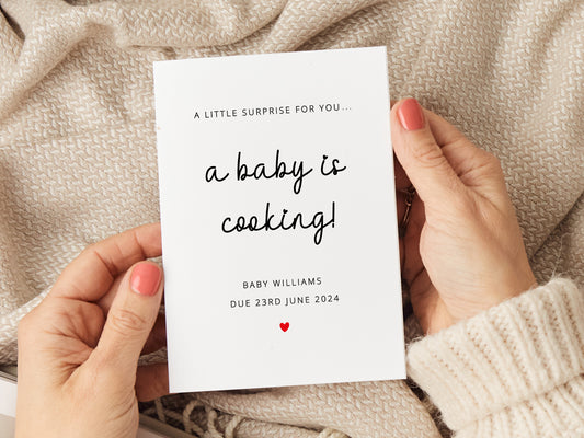 Pregnancy announcement card with reads 'a little surprise for you. A baby is cooking! Baby (name) due (due date).