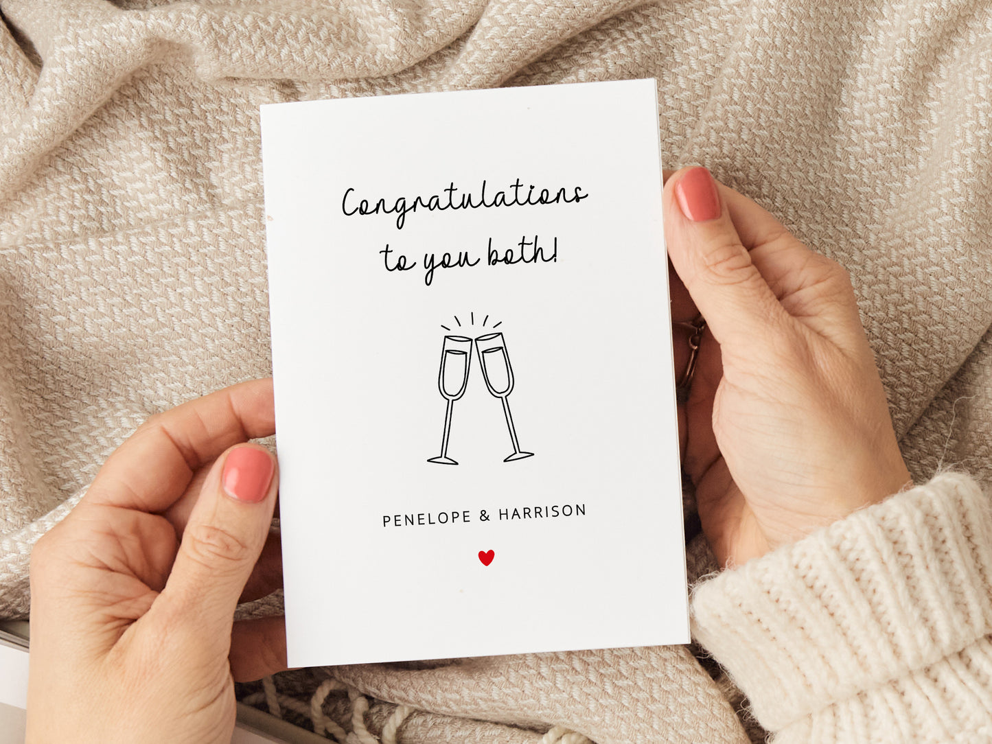 Congratulations card which reads 'congratulations to you both' with a drawing of two champagne glasses and personalised with couples names.