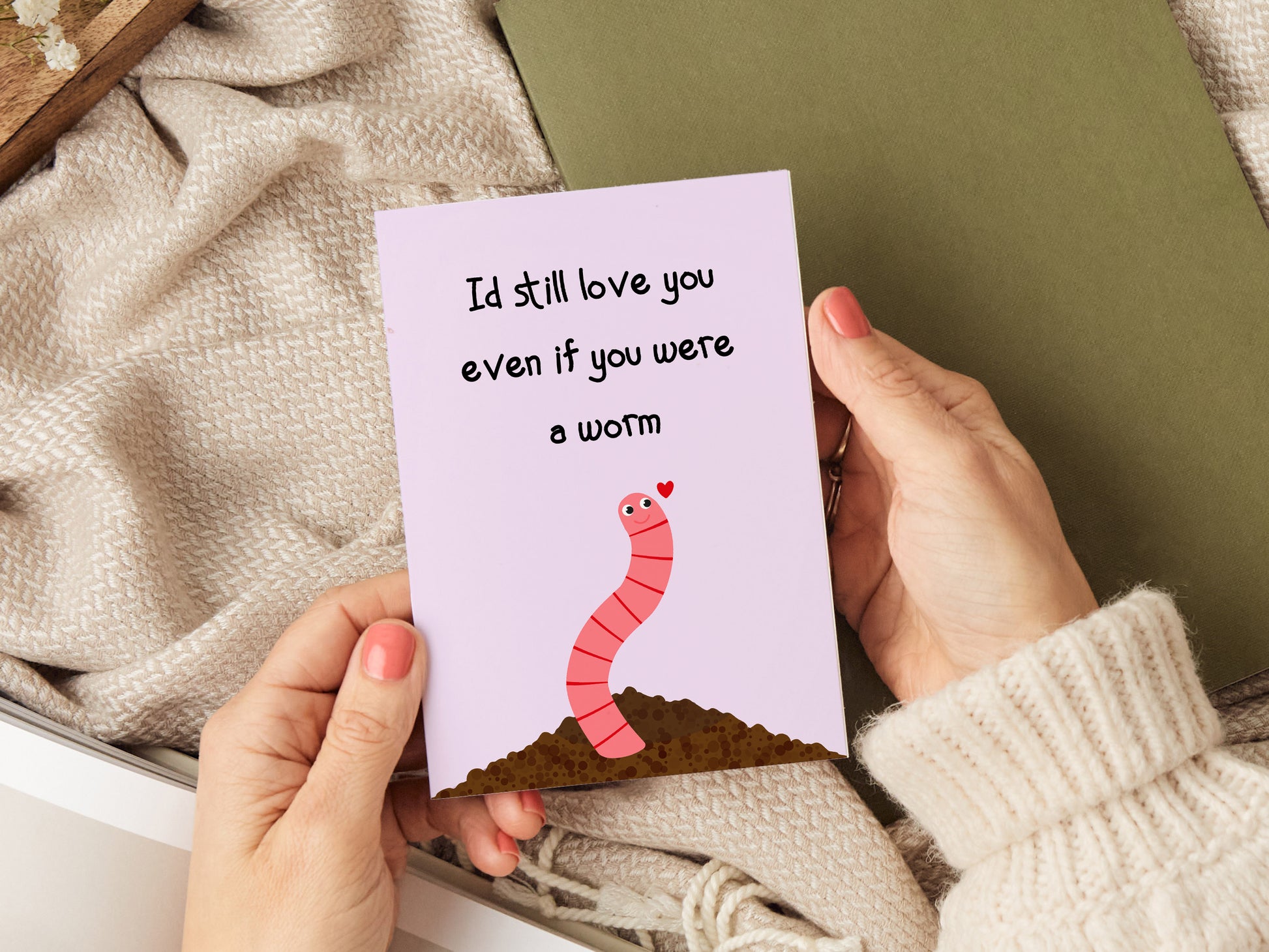 Anniversary card which reads 'I'd still love you even if you were a worm' with a cartoon illustration of a worm coming out of the soil.