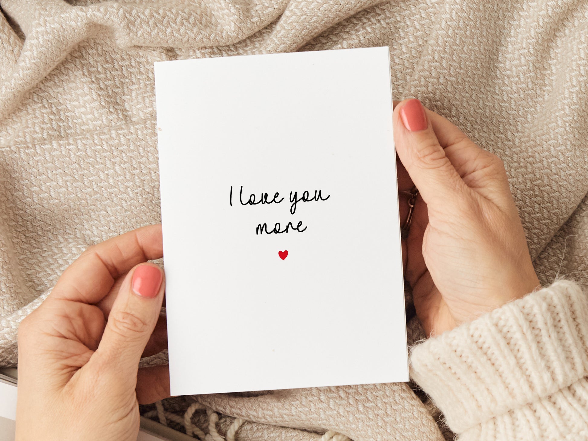 Anniversary card which reads 'I love you more'.