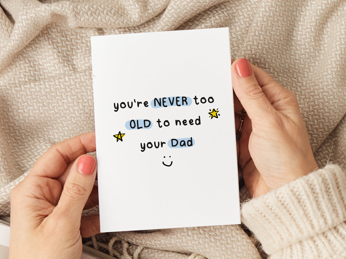 Dad card which reads 'you're never too old to need your dad' with two star illustrations and a smiley face.