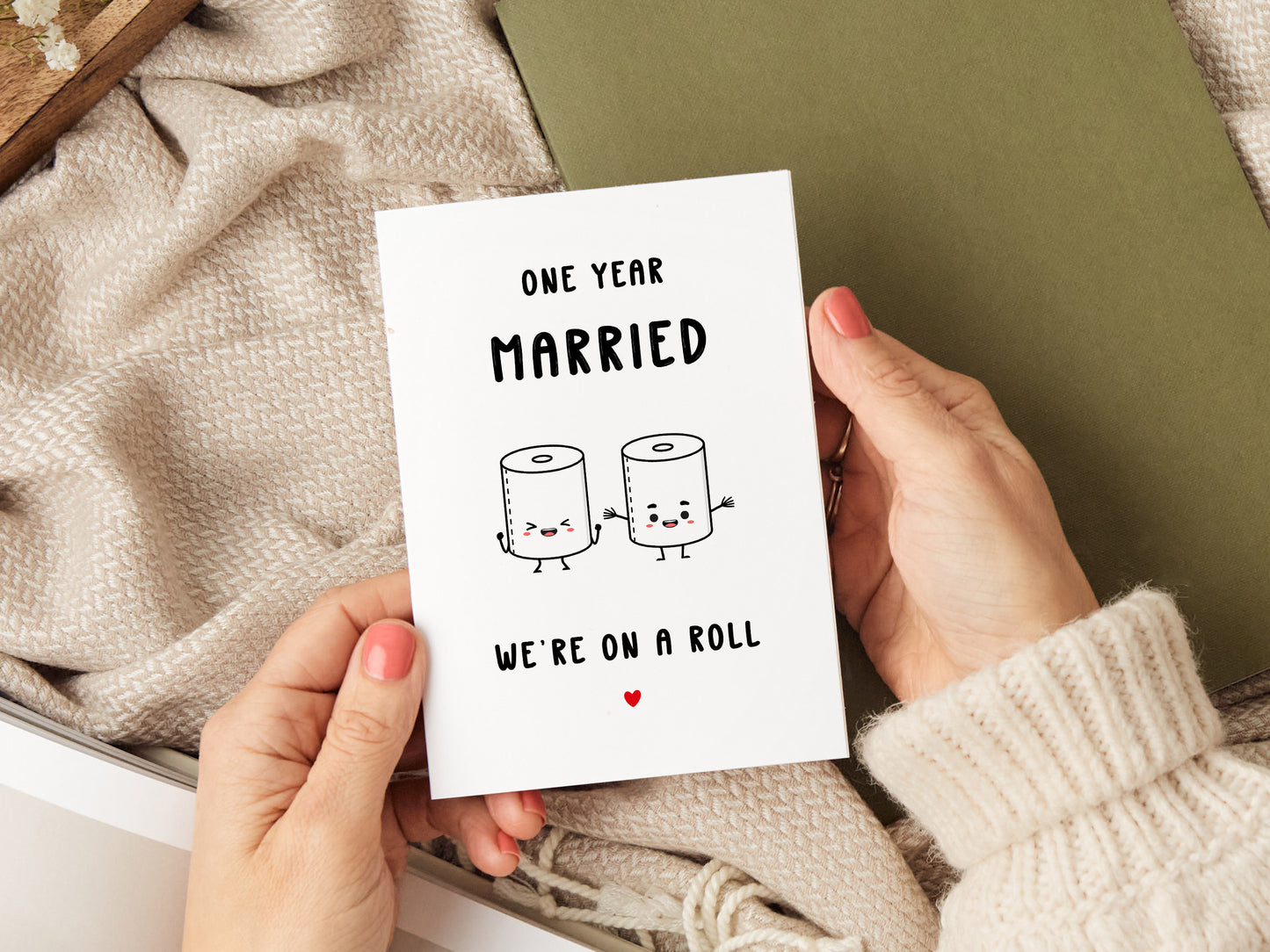 1st wedding anniversary card which reads 'one year married, we're on a roll' with a cartoon of two toilet rolls.