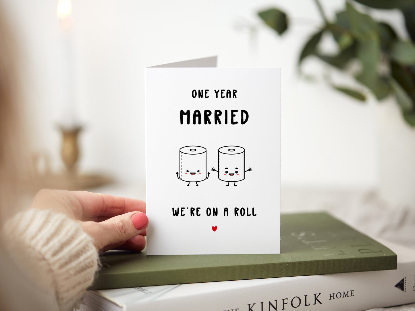 1st wedding anniversary card which reads 'one year married, we're on a roll' with a cartoon of two toilet rolls.