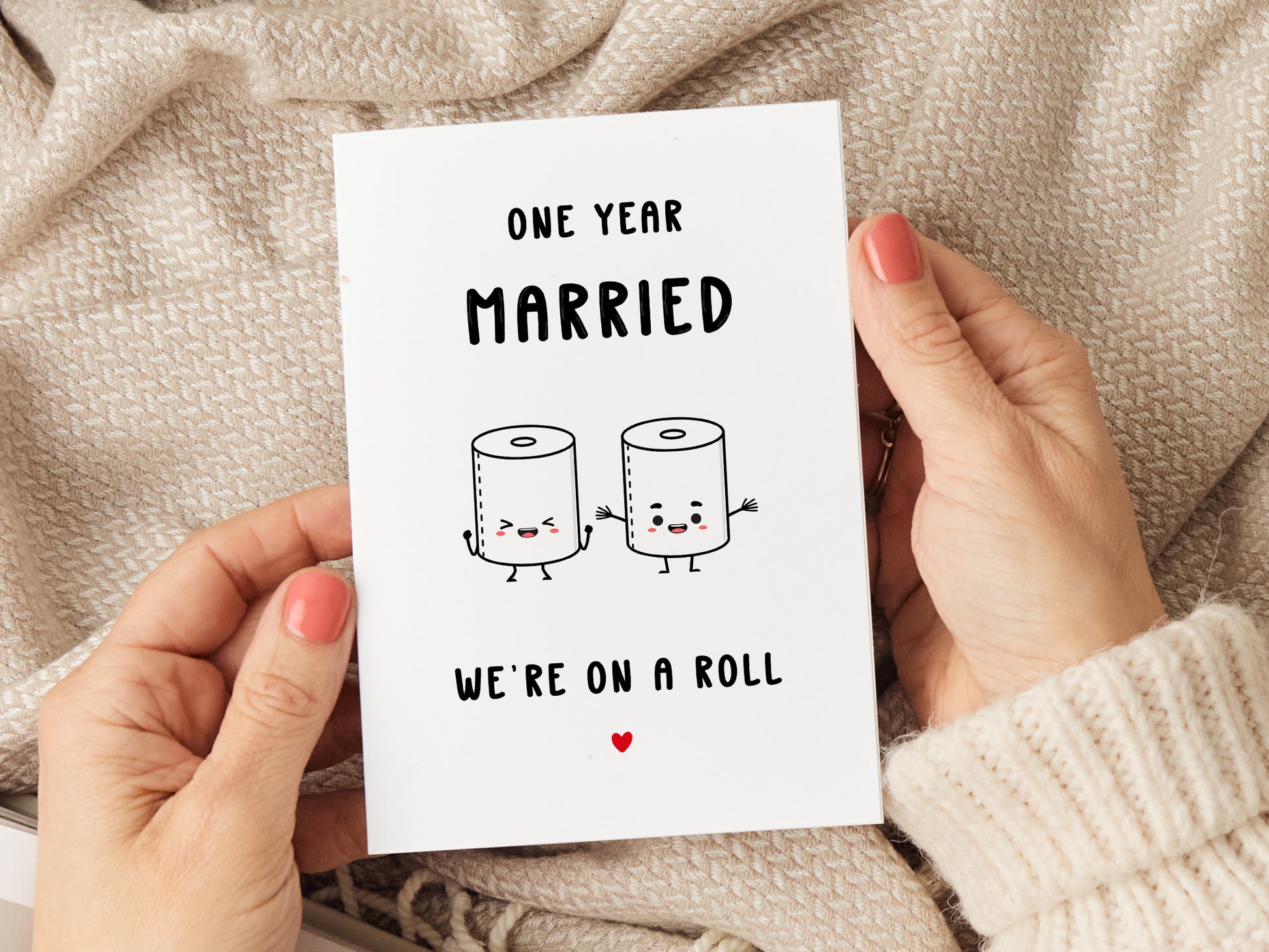 1st wedding anniversary card which reads 'one year married, we're on a roll' with a cartoon of two toilet rolls.