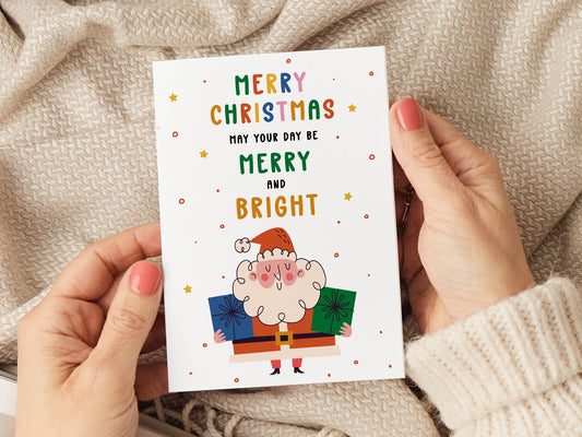 Christmas card which reads 'merry christmas may your day be merry and bright' with an illustration of Santa.