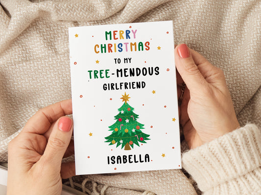 Christmas card which reads 'merry christmas to my tree-mendous girlfriend' with an illustration of a christmas tree.