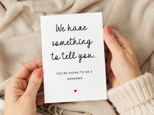 A pregnancy announcement card featuring the message "We have something to tell you... You're going to be a grandma." Perfect for sharing exciting news with the future grandma. Printed on premium card stock and includes a white envelope.